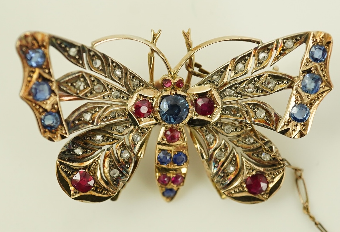 An Edwardian gold, ruby, sapphire and rose cut diamond set butterfly brooch